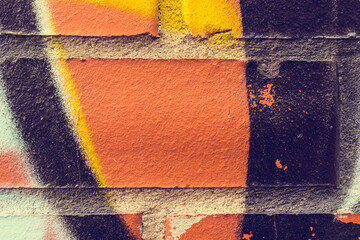 Graffiti on a red brick wall. Close-up view