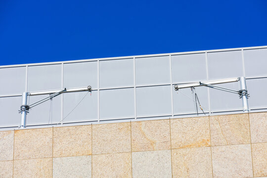 Davit suspension system is attached to the building roof structure.