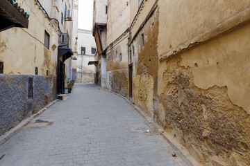 Fototapeta na wymiar Ancient old and narrow street in the medina of Fez. Morocco.