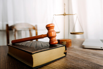 Justice and law concept.Male judge in a courtroom with the gavel, working with, computer and...