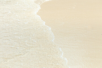 Fototapeta na wymiar Soft blue ocean wave on clean sandy beach 
