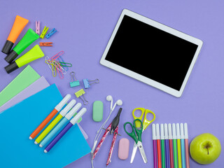 School supplies on violet background, back to school.