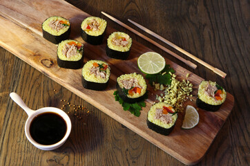 Sushi Set - Different Types of Maki Sushi and Nigiri Sushi. Served on dark wooden table.