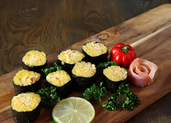 Sushi Set - Different Types of Maki Sushi and Nigiri Sushi. Served on dark wooden table.