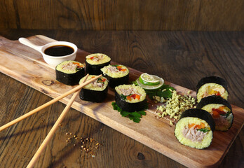 Sushi Set - Different Types of Maki Sushi and Nigiri Sushi. Served on dark wooden table.
