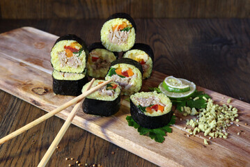 Sushi Set - Different Types of Maki Sushi and Nigiri Sushi. Served on dark wooden table.