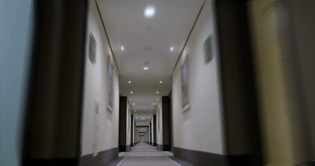 Timelapse of moving forward in empty light hotel corridor