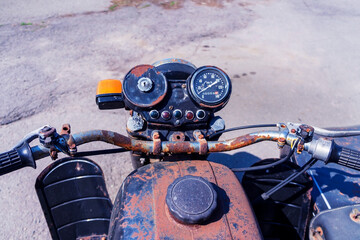 Old rusty motorcycle. Wheel and tank of the vintage motorcycle. Concept of a retro of the technician, outdated model.