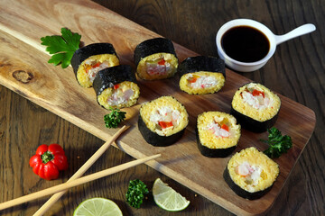 Sushi Set - Different Types of Maki Sushi and Nigiri Sushi. Served on dark wooden table.