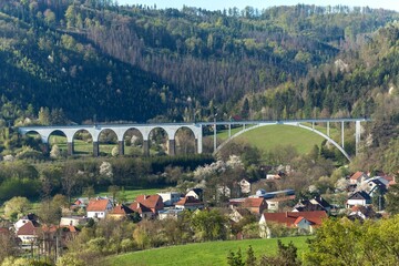 Railway bridge in spring in the Czech Republic of the village Dolni Loucky. Train transport. Spring morning in the countryside.