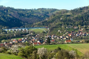 Fototapeta na wymiar Railway bridge in spring in the Czech Republic of the village Dolni Loucky. Train transport. Spring morning in the countryside.
