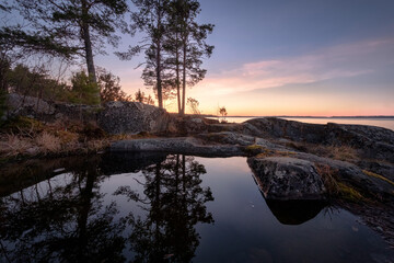 Puddles on the cliffs reflect the grandeur and tranquility of the Ladoga nature
