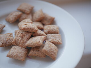 Pillow-shaped cookies on a white plate