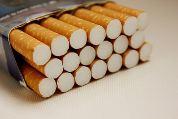 A pack of cigarettes on a white background. open pack of cigarettes. Yellow filter. Harm to health. It is a bad habit. The concept of World No Tobacco, Tobacco and Lung Health. Cigarettes in a tutu.