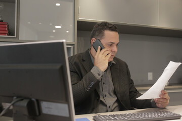 businessman working on laptop, cell phone