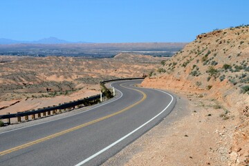 The lonely, curved rural desert road on the outskirts of Logandale Clark County Nevada.