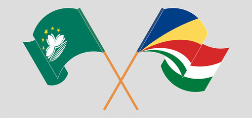 Crossed and waving flags of Macau and Seychelles
