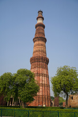 Fototapeta na wymiar The Qutb Minar, also spelled as Qutub Minar and Qutab Minar, is a minaret and 