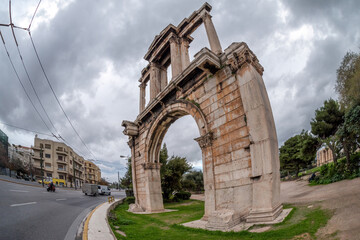 Fototapeta na wymiar Athens, Attica - Greece. The Arch of Hadrian, most commonly known in Greek as Hadrian's Gate. Vasilissis Amalias Avenue. The archaeological site of Olympieion (Temple of Olympian Zeus) on the right