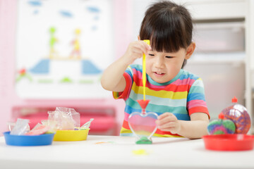 Fototapeta premium young girl making sand crafts for home schooling