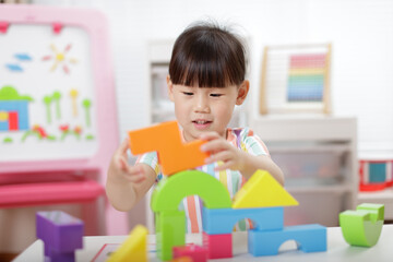 young girl playing creative blocks at home