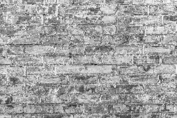 old  brick wall painted with white with  color peeling