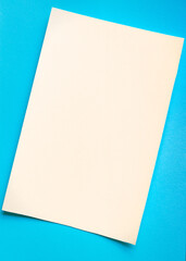 Blue and milky minimalistic background. Paper in two colors. Texture backdrop. Concept of contrast and minimalism.