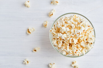 bowl with homemade popcorn on wooden background.