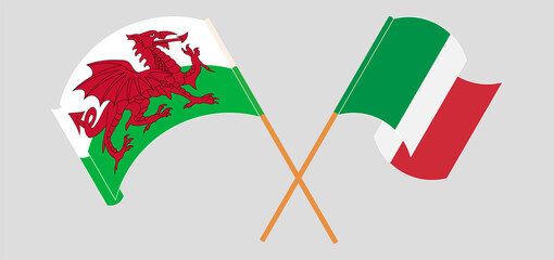 Crossed and waving flags of Wales and Italy