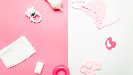 baby care and health concept. Children's personal care kit. Set with soap, clothes, toys. White, pink background. frame. space for text