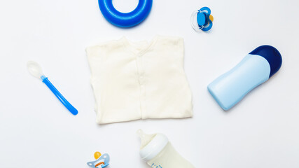 Baby shower concept. baby clothes for little boy. Set of blue toys and light clothing. mock up. top view. Kids accessories