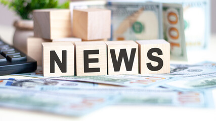 wooden blocks with text news and banknotes on table, concept