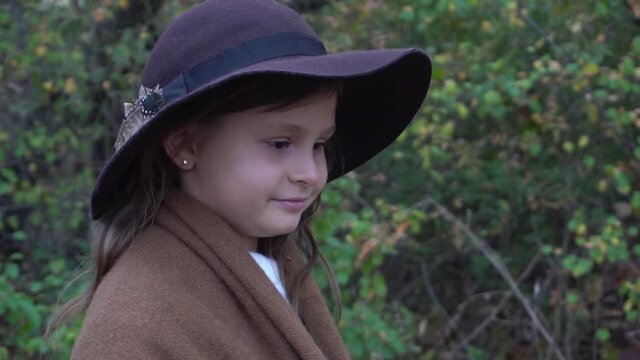 Slow Motion Autumn portrait of beautiful girl in a hat