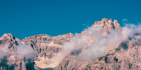 Clouds over mountain peaks in the Dolomites, Italy.