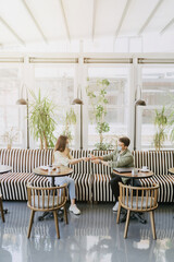 Young couple using disinfectant at coffee shop