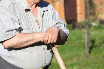Fototapeta na wymiar Senior Man Hands holding a garden tool