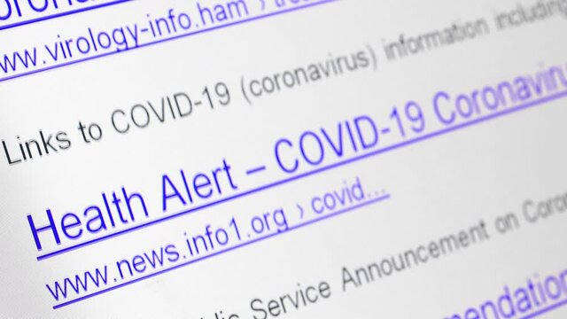 Internet search results for coronavirus with The links of imaginary no-existing websites move on a display, close up.