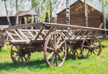 Fototapeta na wymiar Old worn out wooden cart in the village