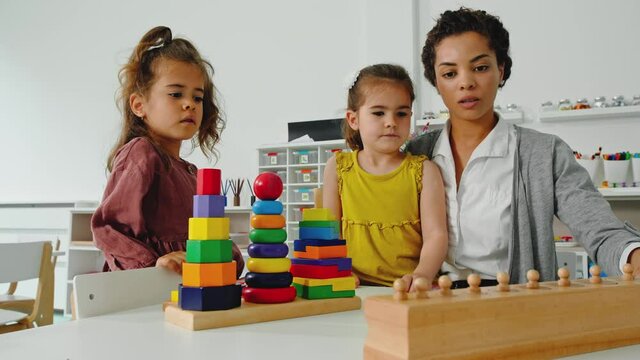 Teacher playing with two girls.