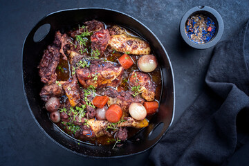 Modern style traditional French coq au vin with vegetable marinated in Burgundy sauce as top view...