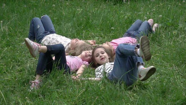 Slow Motion Little friends laying on grass in summer park