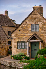 Fototapeta na wymiar Houses by a stream in Lower Slaughter, Gloucestershire, Cotswolds, England