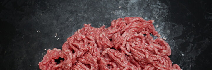 Raw Minced Meat On Black Vintage Background. Top View Of Fresh Ground Beef Isolated On Black Background. Uncooked Minced Mixed Beef And Pork Meat.