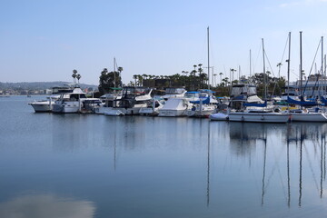 Fototapeta na wymiar Boats in a Mission Bay, San Diego, California, Marina and Harbor Moored in Peaceful Calm Waters