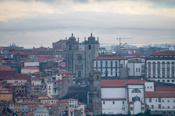 Fototapeta na wymiar Panoramic view on Douro river and old part of Porto city in Portugal at cloudy sunrise