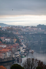 Fototapeta premium Panoramic view on Douro river and old part of Porto city in Portugal at cloudy sunrise