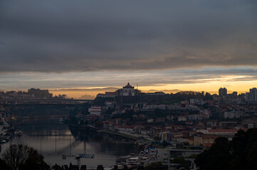 Panoramic view on Douro river and old part of Porto city in Portugal at cloudy sunrise