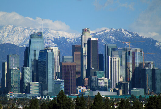 downtown los angeles skyline in the winter with white snowcaps