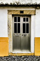 Fototapeta na wymiar Old and colorful gray metal door