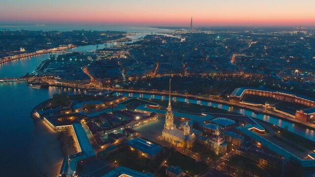 Drone flies off the Peter and Paul cathedral and fortress at evening, the sights of St. Petersburg, the Neva river, the Hermitage museum, Rostral columns, bridges, St. Isaac cathedral, the Admiralty